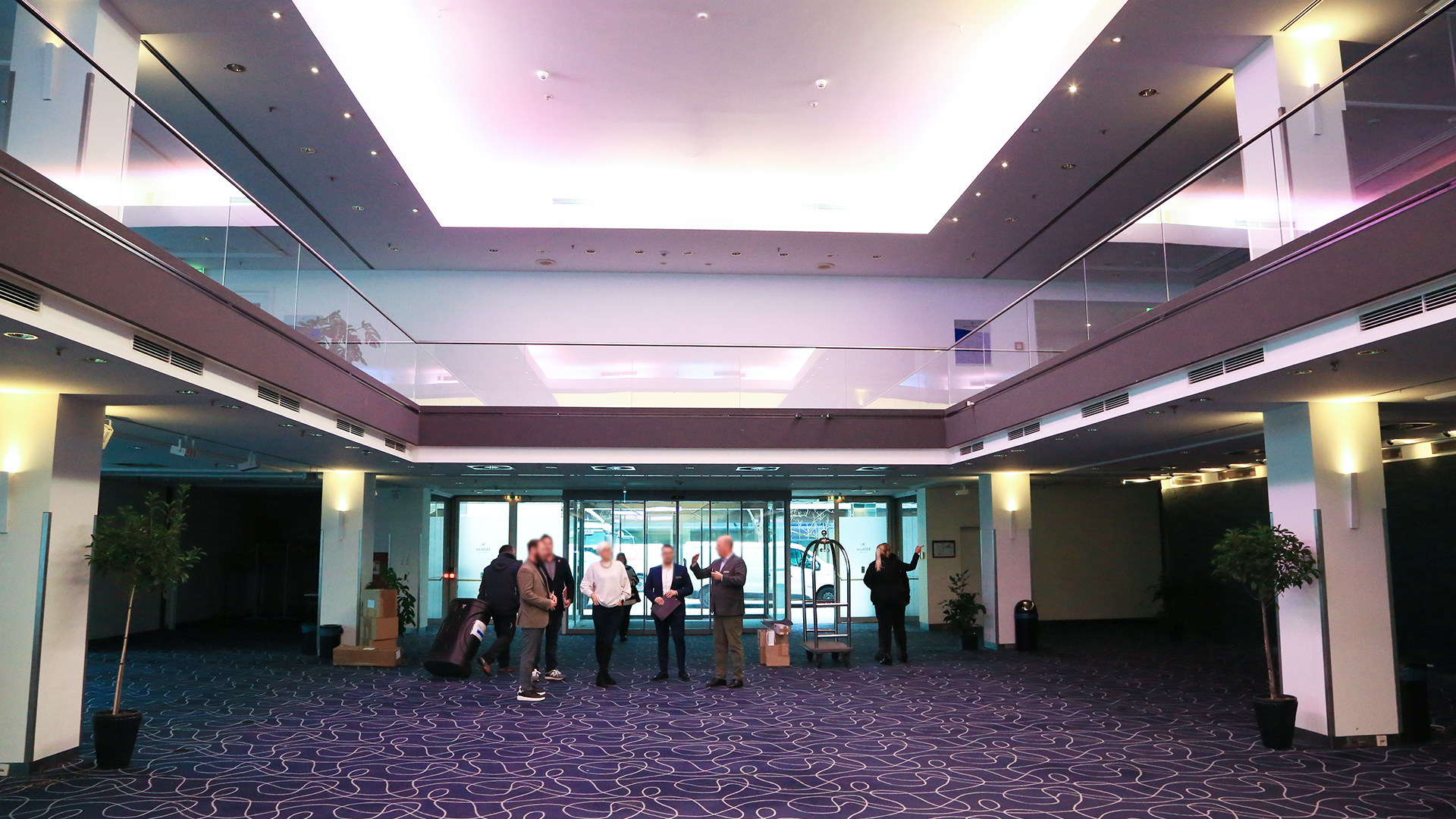 Meeting planners conducting a site survey with Brella's Event Manager in the lobby of a convention center.