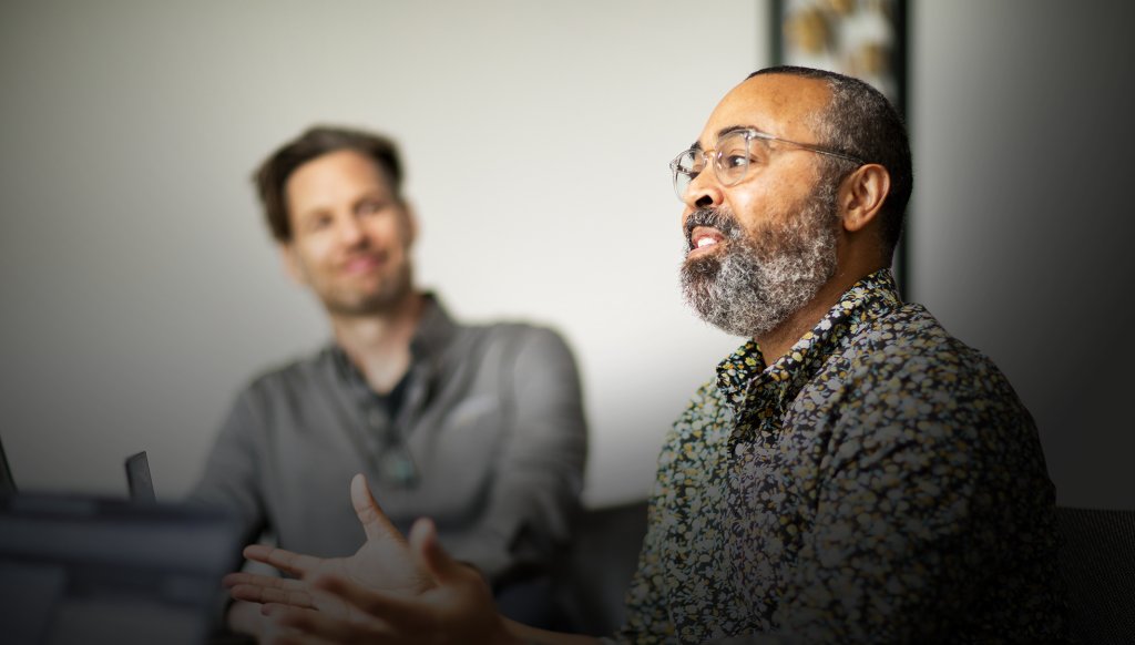 A male Brella event management agency team members share his thoughts during a meeting.