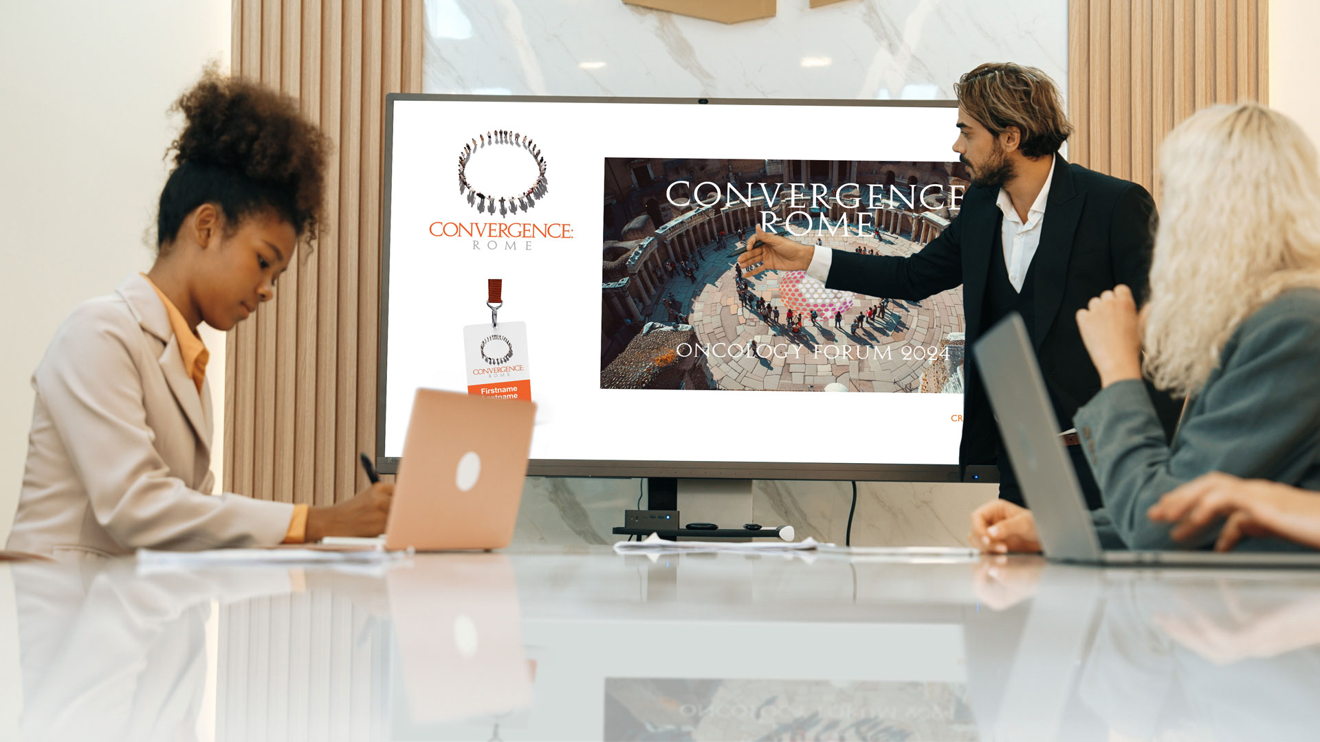 Man presents coporate conference theme concepts to female colleagues.