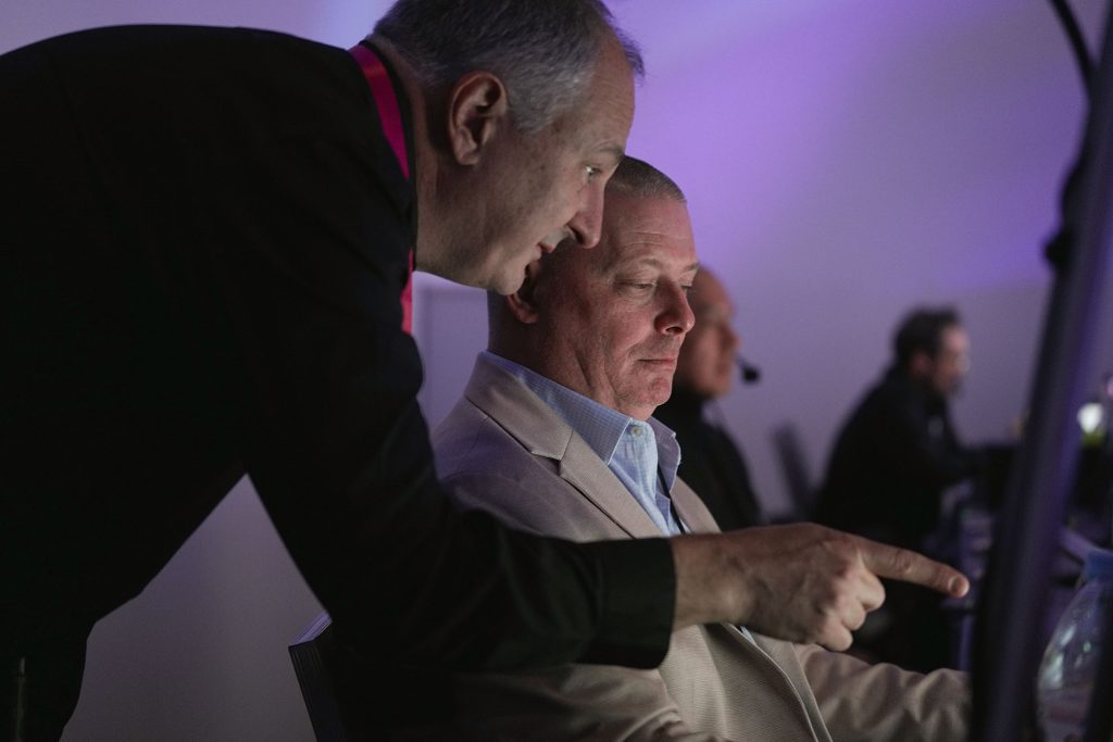 Mark Mallchok, Brella's Sr. Event Strategist, consults with an event management producer during a live corporate event.